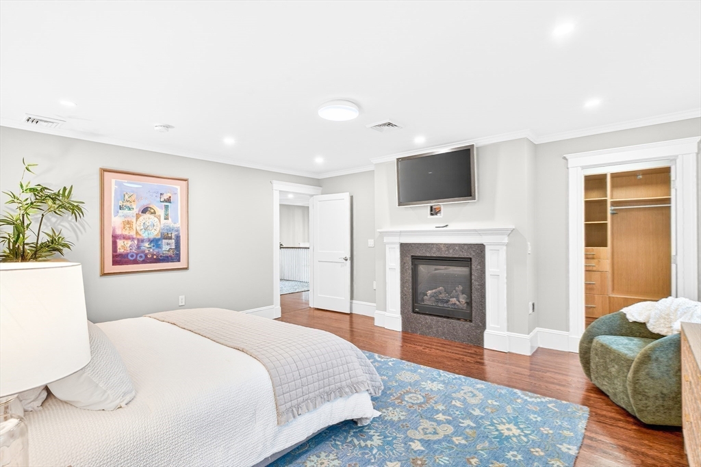524 Ward Street Newton, MA 02459 - Photo 23 of 42 a bedroom with a bed and a fireplace
