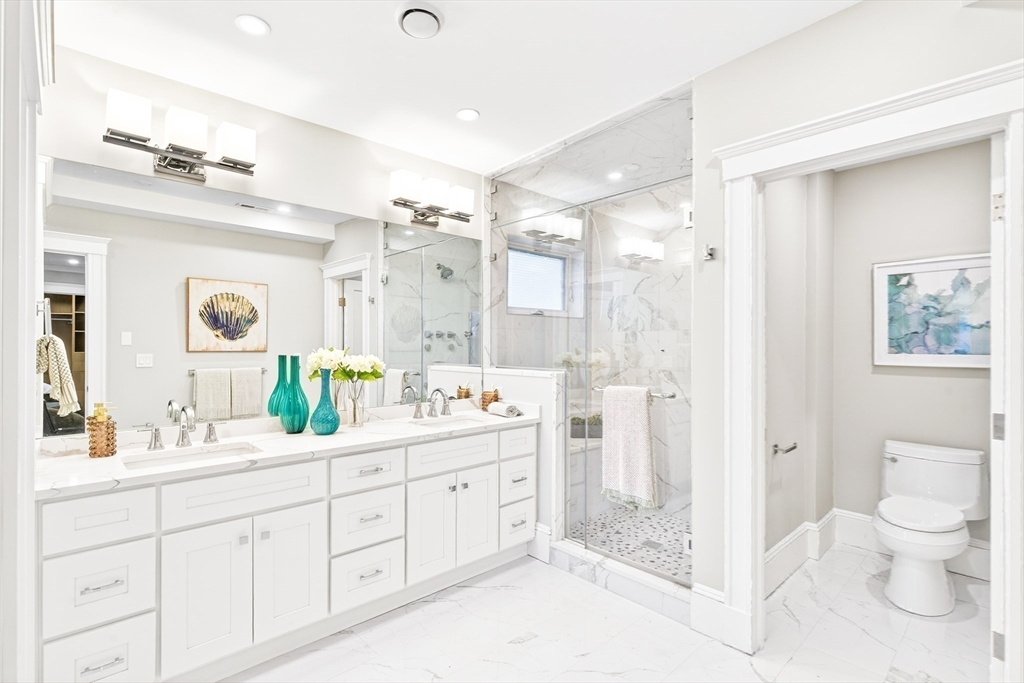 524 Ward Street Newton, MA 02459 - Photo 25 of 42 a spacious bathroom with a double vanity sink toilet mirror and shower