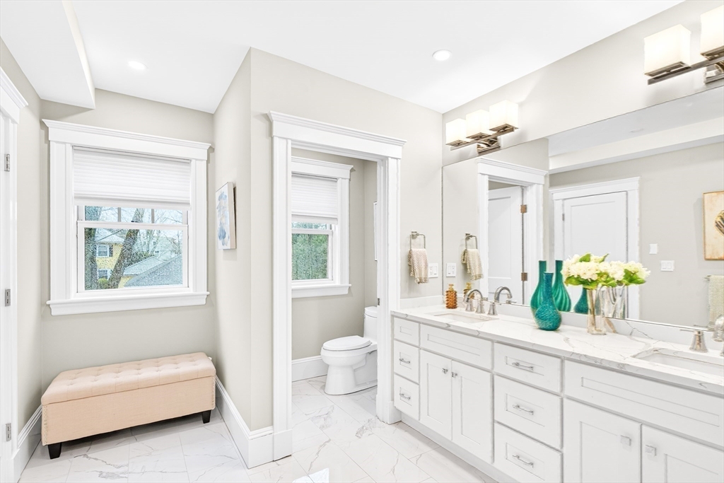 524 Ward Street Newton, MA 02459 - Photo 26 of 42 a bathroom with a double vanity sink toilet and a mirror