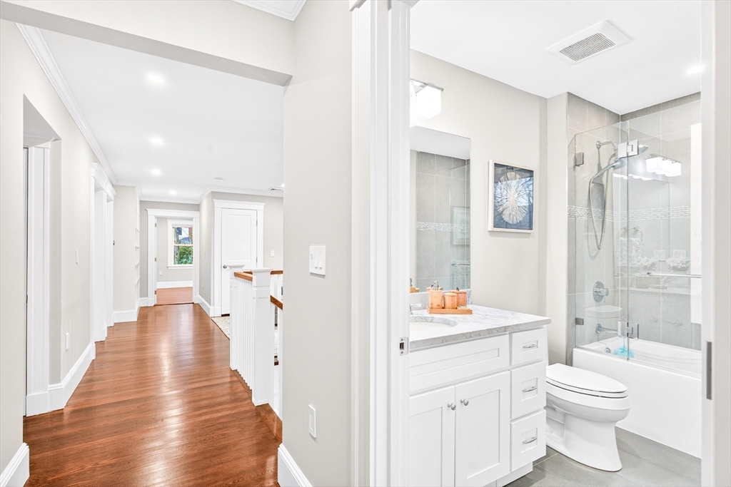 524 Ward Street Newton, MA 02459 - Photo 29 of 42 a bathroom with a toilet a sink and a large mirror