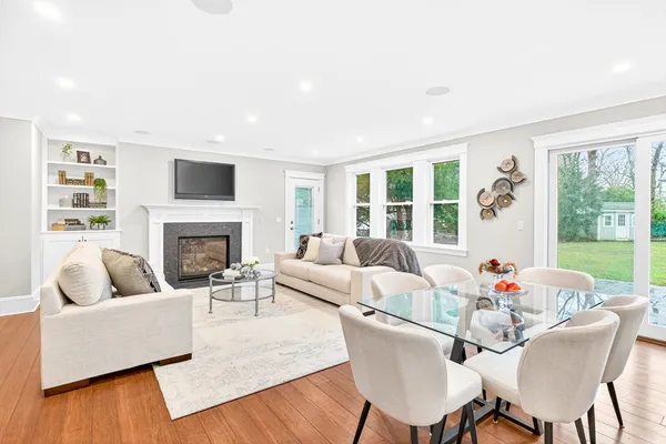 a living room with furniture fireplace and a large window
