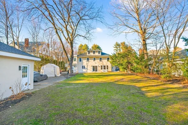 a view of a house with a large trees and a big yard