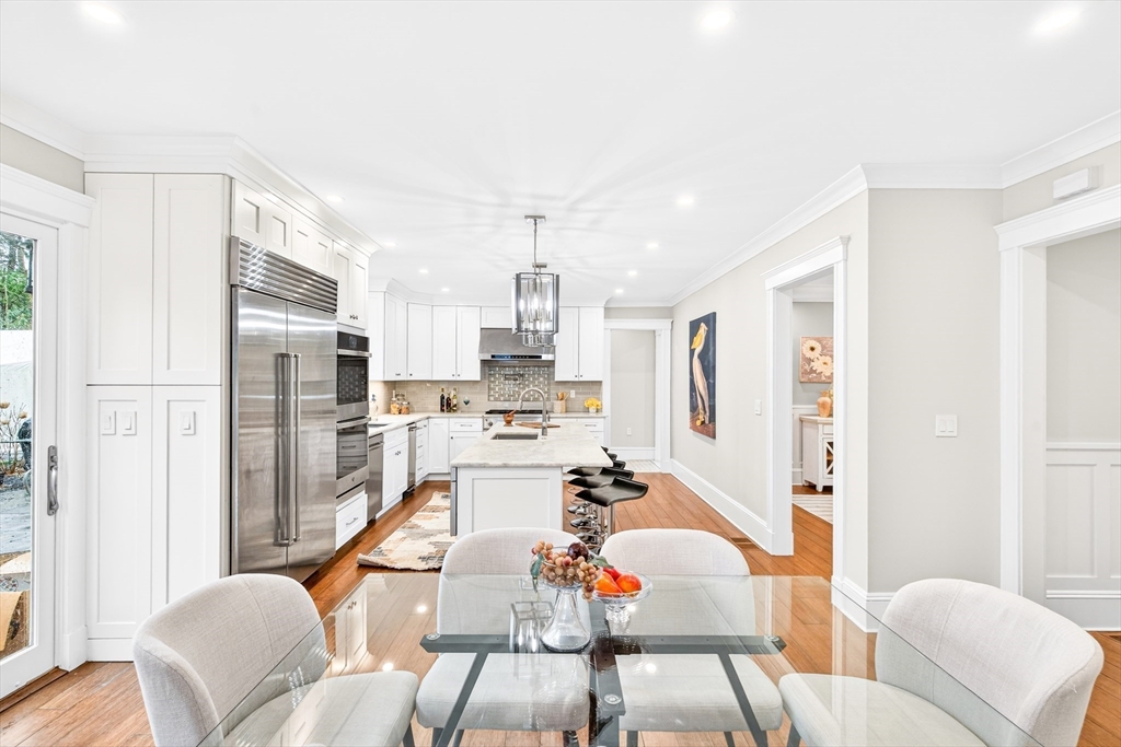 524 Ward Street Newton, MA 02459 - Photo 5 of 42 a dining room with stainless steel appliances furniture a large window and a refrigerator