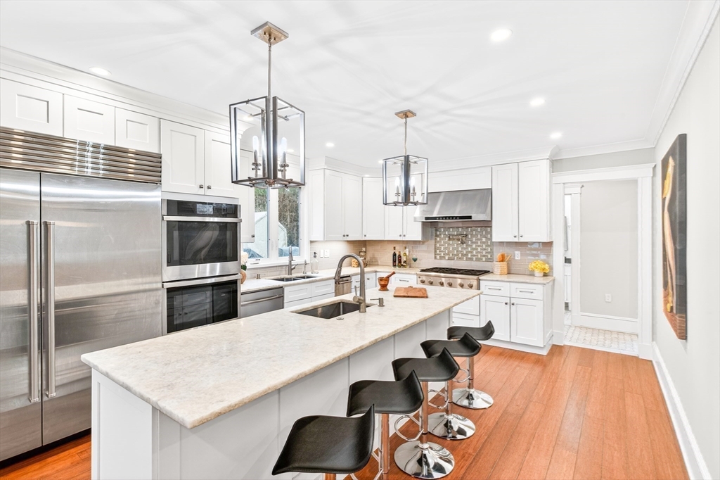 524 Ward Street Newton, MA 02459 - Photo 6 of 42 a kitchen with refrigerator cabinets and wooden floor