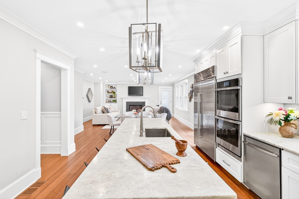 524 Ward Street Newton, MA 02459 - Photo 7 of 42 a living room with stainless steel appliances furniture a rug kitchen view and a chandelier