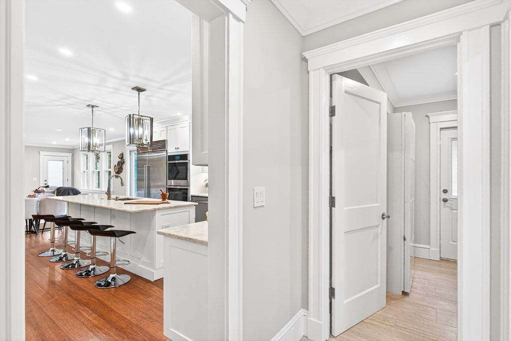 524 Ward Street Newton, MA 02459 - Photo 8 of 42 a living room with stainless steel appliances kitchen island granite countertop furniture and a chandelier