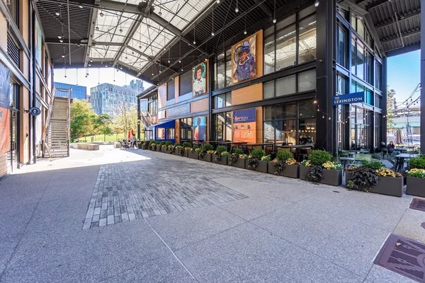 a street view with tall buildings and a yard