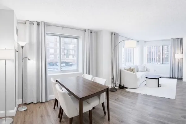 a view of a room with furniture and wooden floor