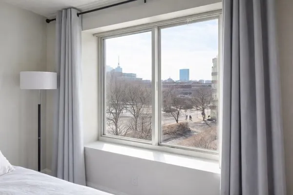 a view of a room that has a bed and a window