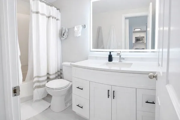a bathroom with a sink toilet and shower