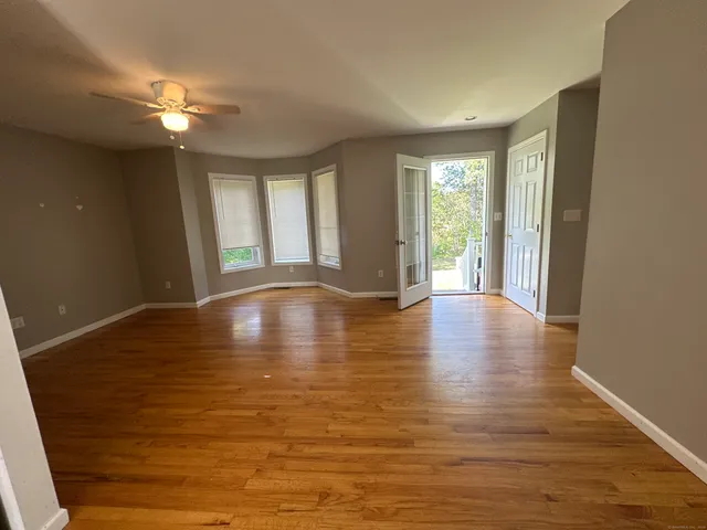 a view of room with window and wooden floor
