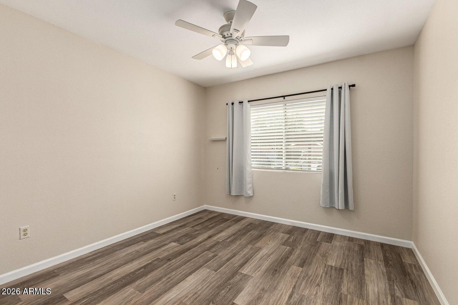 1825 West Ray Road, Unit 1148 Chandler, AZ 85224 - Photo 25 of 36 wooden floor in an empty room with a window