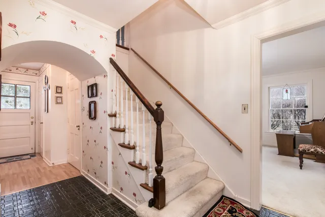 a view of entryway and hall with wooden floor