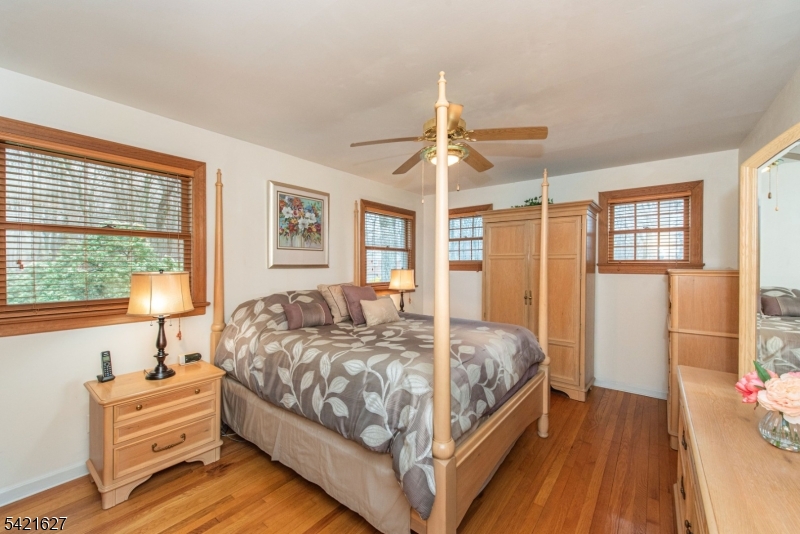 4 Oak Ridge North Caldwell, NJ 07006 - Photo 14 of 33 a bedroom with a bed chandelier and a window