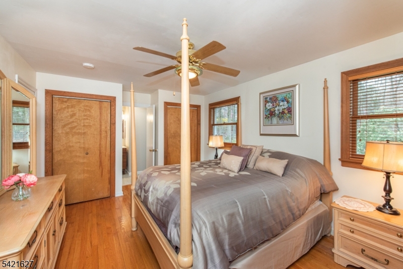 4 Oak Ridge North Caldwell, NJ 07006 - Photo 15 of 33 a bedroom with a bed and a chandelier