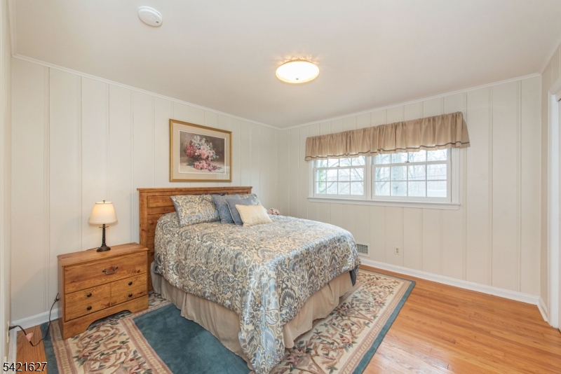 4 Oak Ridge North Caldwell, NJ 07006 - Photo 19 of 33 a bedroom with a bed and wooden floor