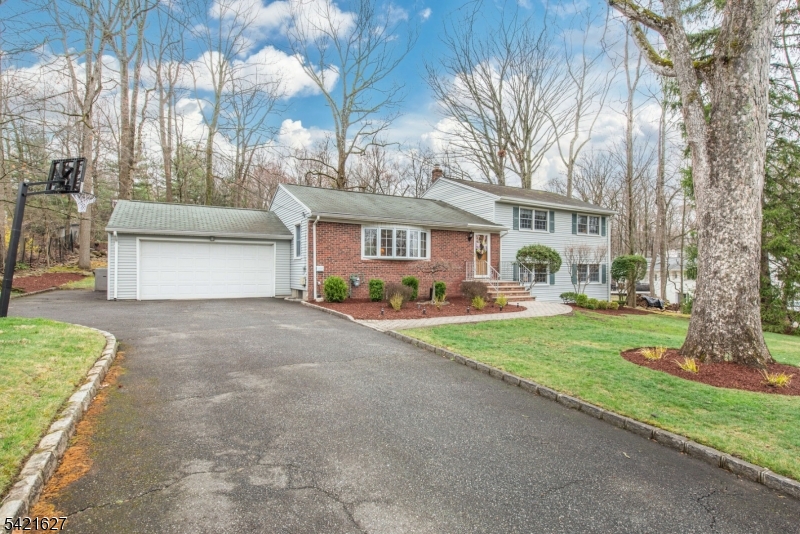 4 Oak Ridge North Caldwell, NJ 07006 - Photo 2 of 33 a front view of a house with a yard and garage