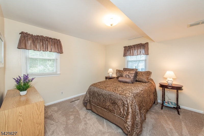 4 Oak Ridge North Caldwell, NJ 07006 - Photo 25 of 33 a bedroom with a bed and a potted plant