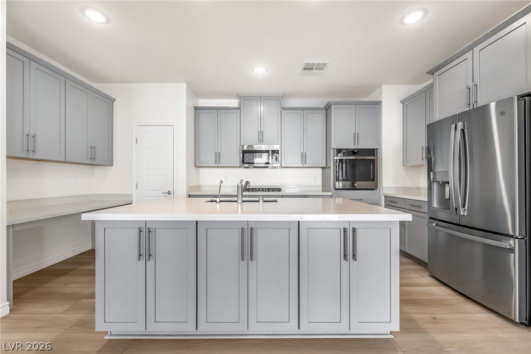 2555 Hampton Road, Unit 10108 Henderson, NV 89052 - Photo 9 of 23 An expansive central island and modern cabinetry anchor this contemporary kitchen space.