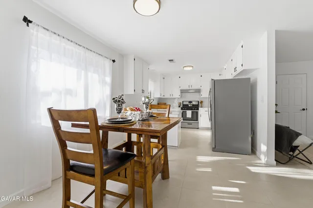 a dining room with furniture and window