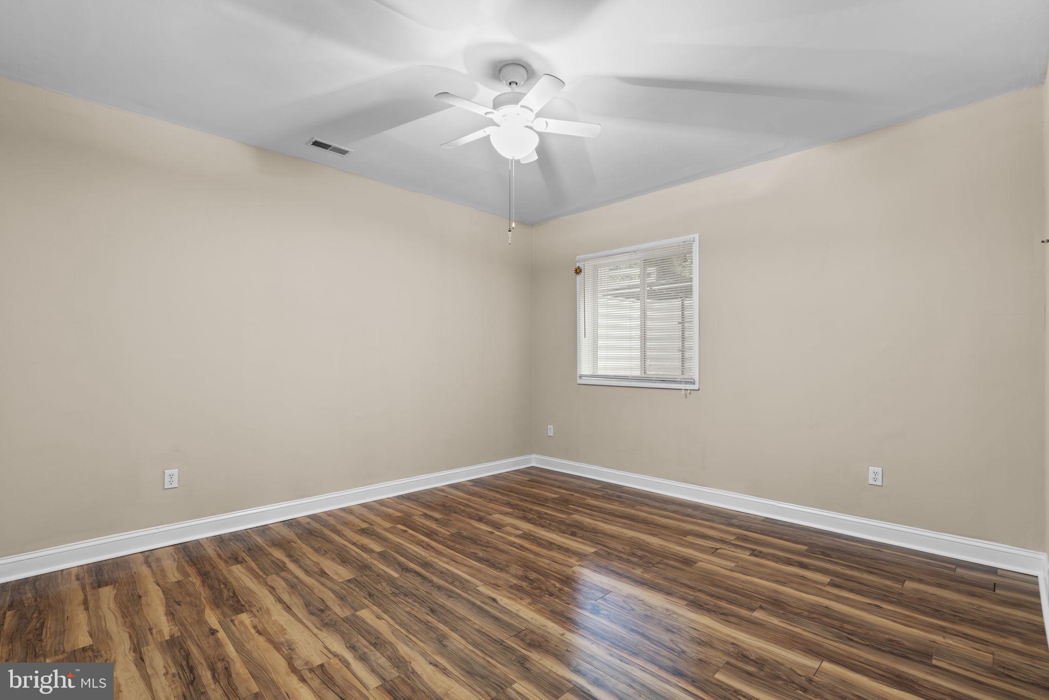 8024 Solley Road Glen Burnie, MD 21060 - Photo 66 of 83 a view of a room with wooden floor and a ceiling fan