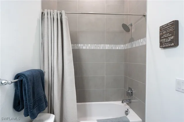 a bathroom with a shower and a toilet