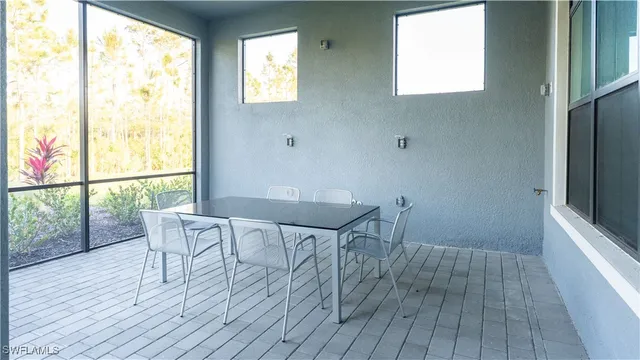 a view of a room with wooden floor and windows