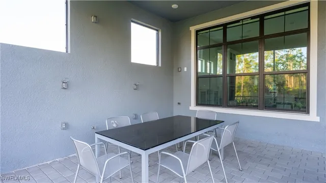 a view of a dining room with furniture and window