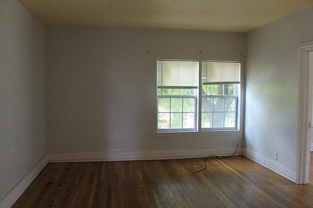 2908 Truxillo Street Houston, TX 77004 - Photo 3 of 12 an empty room with wooden floor and windows