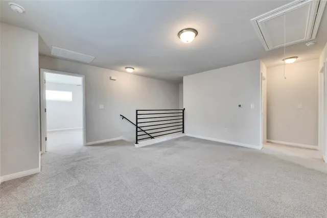 an empty room with windows and ceiling fan