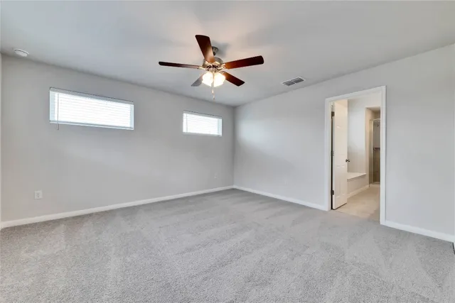 an empty room with closet and windows