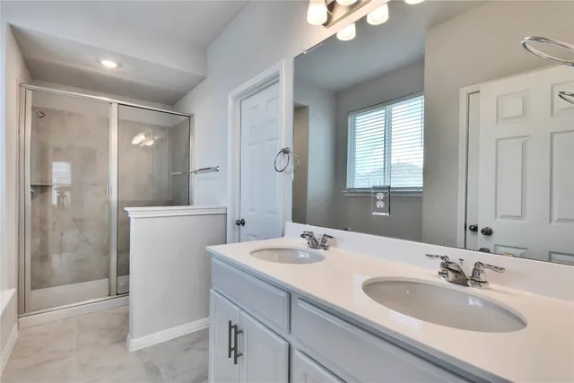 a bathroom with a sink tub and a mirror