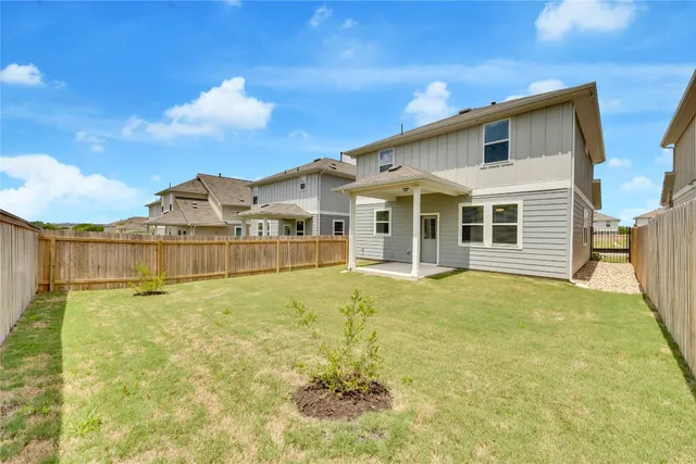 a view of a house with a backyard