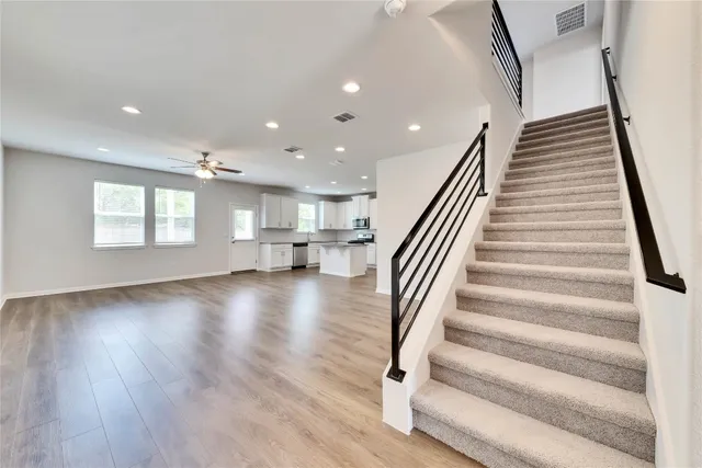 a view of entryway and hall with wooden floor