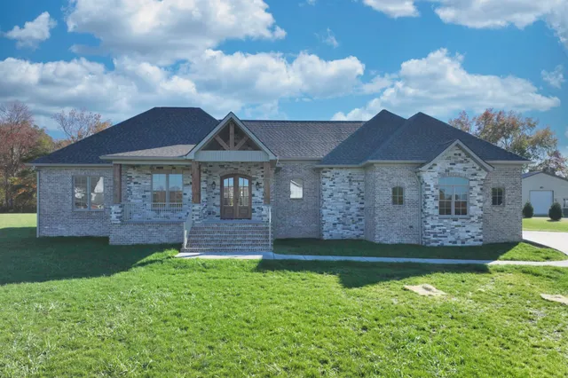a front view of a house with a garden