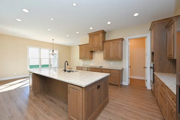 a kitchen with a sink stove and refrigerator
