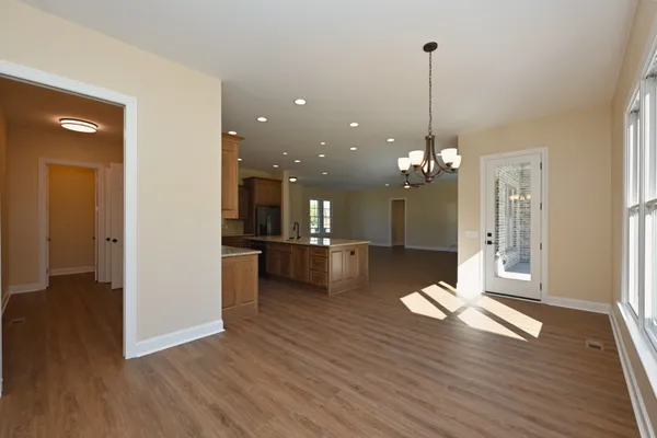a view of a dining room with furniture wooden floor and a chandelier