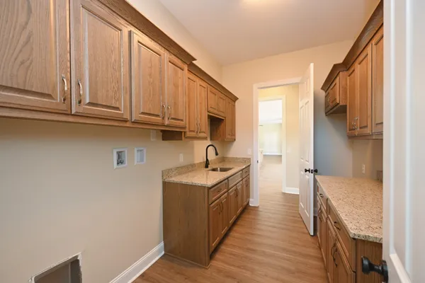 a kitchen with a sink a refrigerator and cabinets