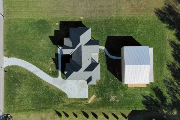a aerial view of a house with a yard