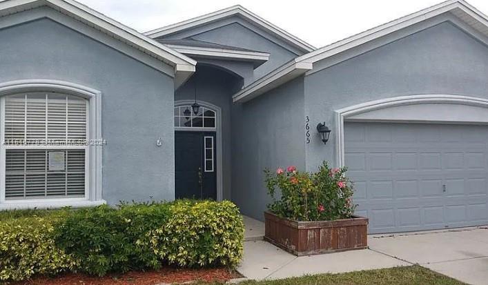 3665 Barred Owl Road Lakeland, FL 33811 - Photo 2 of 7 a front view of a house with a yard