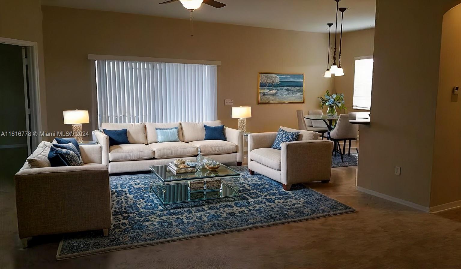 3665 Barred Owl Road Lakeland, FL 33811 - Photo 3 of 7 a living room with furniture and a chandelier