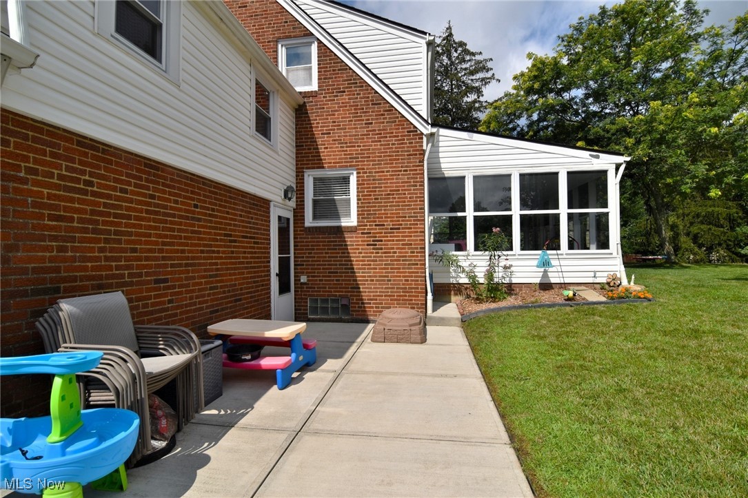 6525 East Pleasant Valley Road Independence, OH 44131 - Photo 33 of 38 Concrete patio area with view of sunroom.