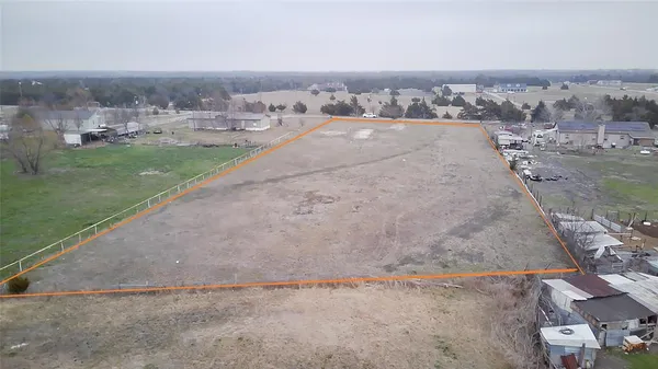 an aerial view of a house with a yard and lake view