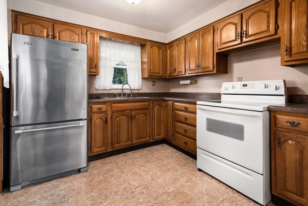 60 Fezell Road Freedom, PA 15042 - Photo 6 of 21 a kitchen with appliances a refrigerator and cabinets