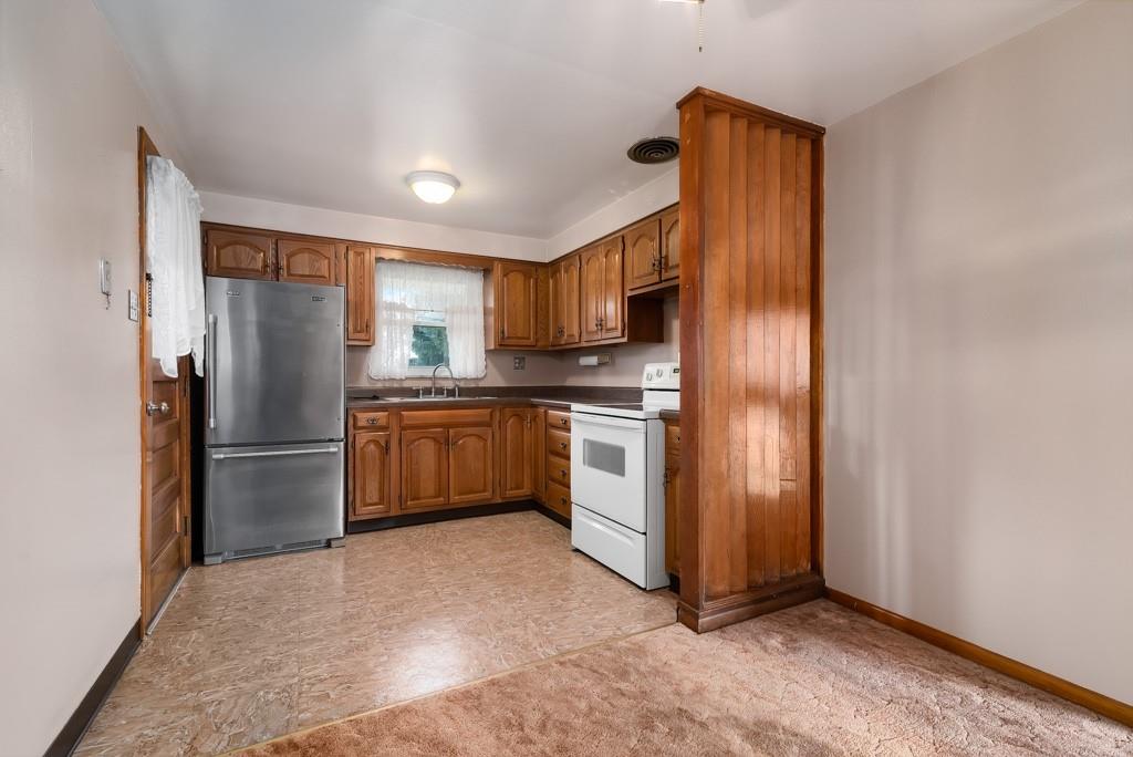 60 Fezell Road Freedom, PA 15042 - Photo 7 of 21 a kitchen with white cabinets and stainless steel appliances