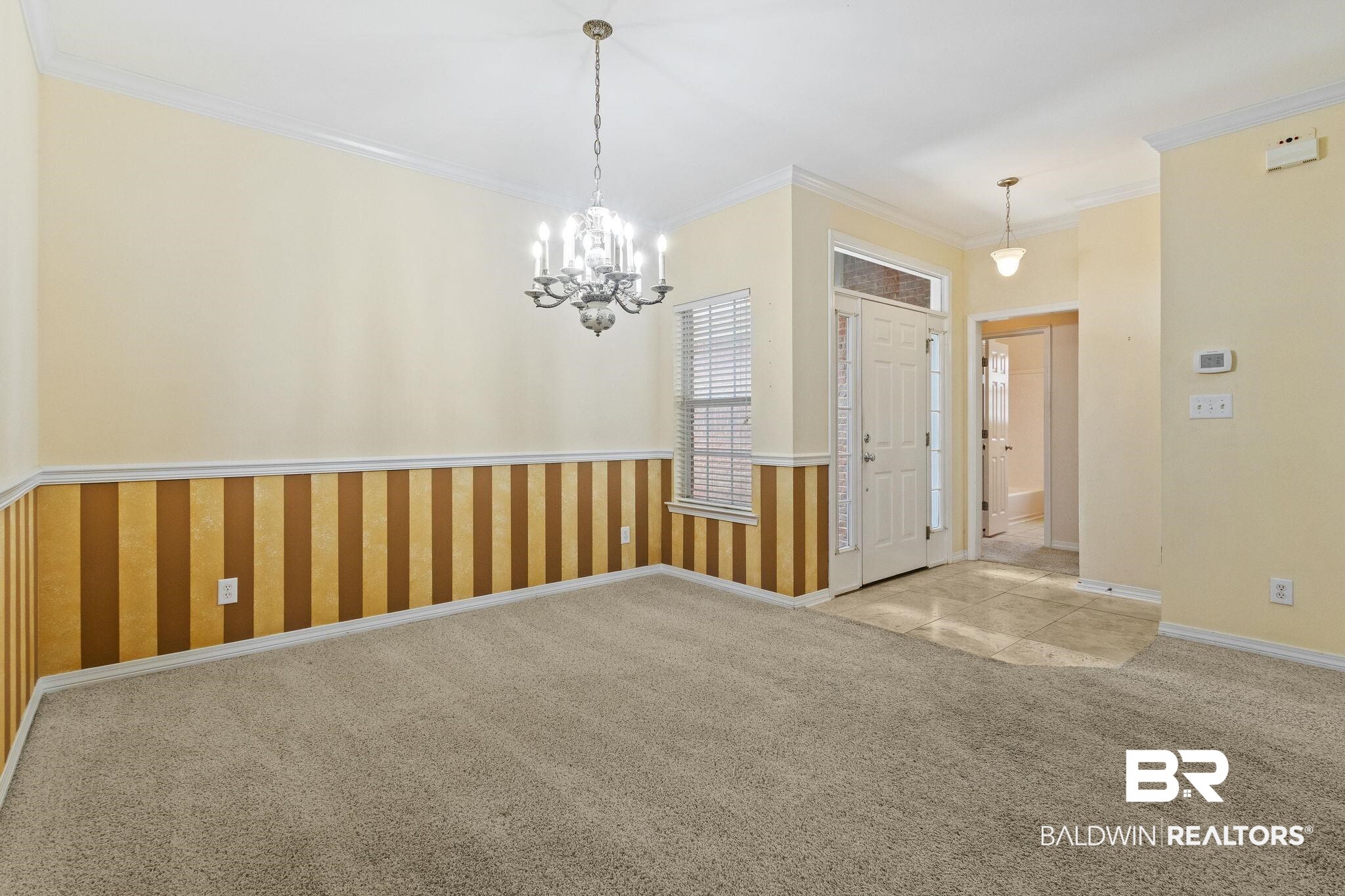 166 Club Drive Fairhope, AL 36532 - Photo 5 of 41 Carpeted spare room with an inviting chandelier and crown molding