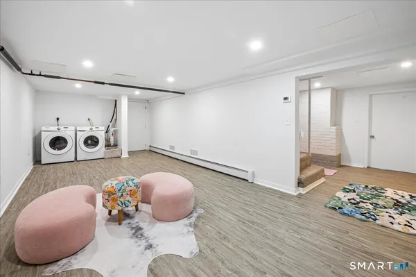 a living room with furniture and wooden floor