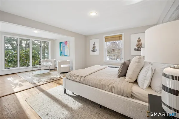 a bedroom with a large bed and a large window