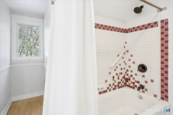 a bathroom with a bathtub and shower