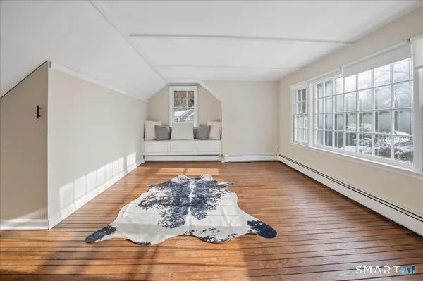 a room with view of a floor to ceiling window and wooden floor